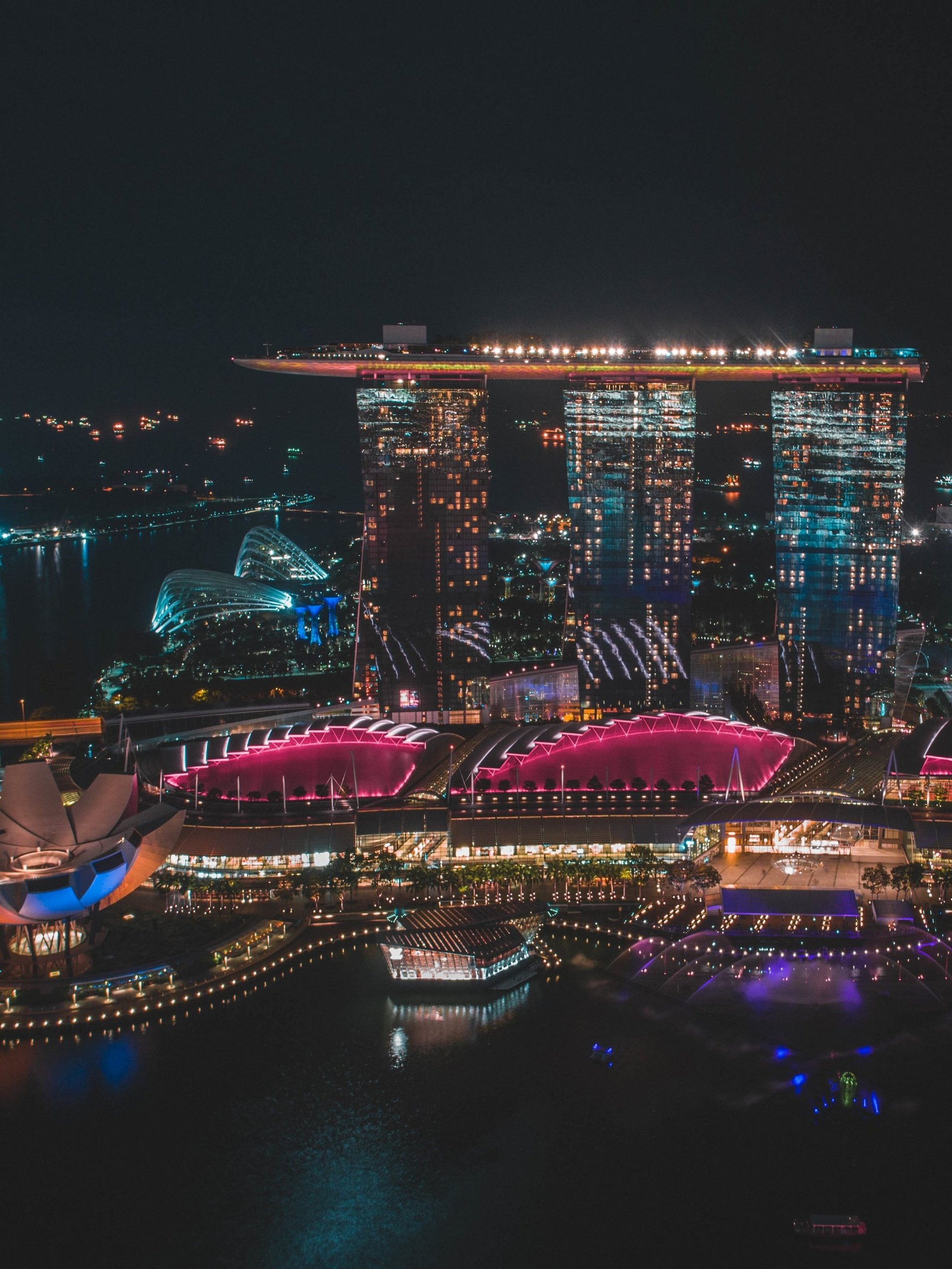 Vertical distant shot of Singapore Marina Bay Sands during nighttime in Singapore